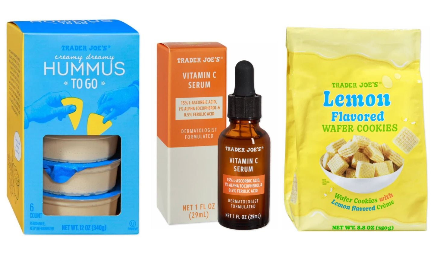Three Trader Joe’s products: a blue box of Creamy Dreamy Hummus To Go, a bottle and box of Vitamin C Serum, and a yellow bag of Lemon Flavored Wafer Cookies with lemon-flavored crème.