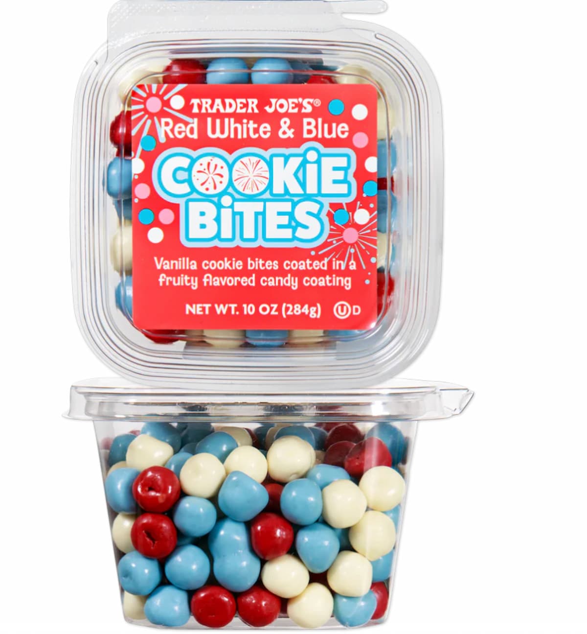 A clear plastic container of Trader Joe’s Red White & Blue Cookie Bites, featuring red, blue, and white candy-coated vanilla cookie bites, with a colorful label on the lid.