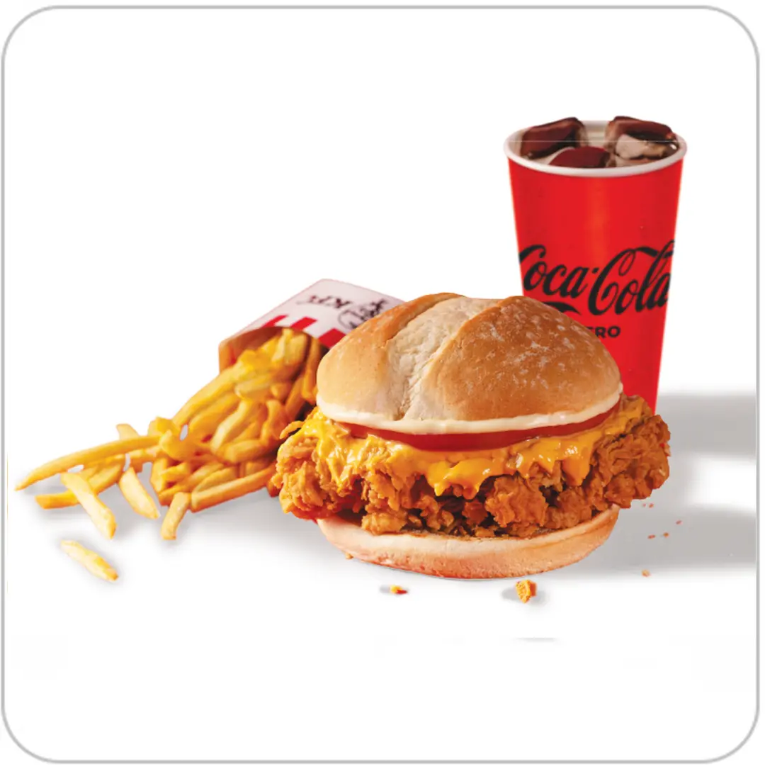 A meal featuring a crispy Chicken Sandwich topped with cheese, served alongside golden French fries and a chilled cup of Coca-Cola on a white background.