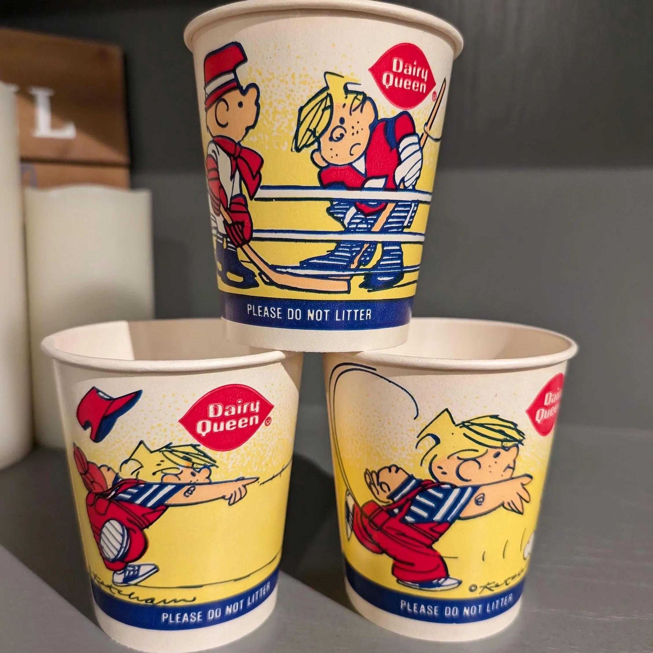 Three vintage Dairy Queen cups with cartoon illustrations of a blond boy playing baseball, wearing a red cap and blue outfit. The cups say “PLEASE DO NOT LITTER” near the bottom.