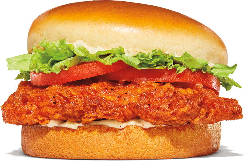 A crispy Chicken Sandwich with lettuce, tomato slices, and mayonnaise in a soft, golden bun, set against a plain white background.