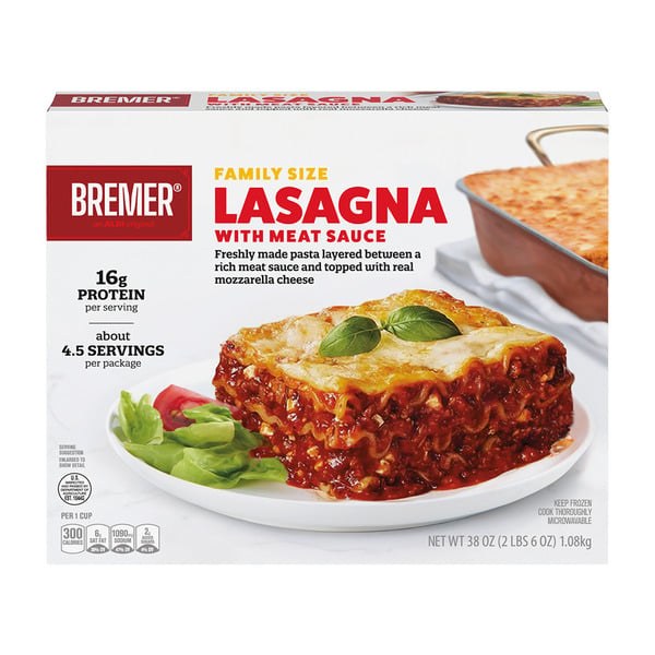 A box of Bremer Family Size Lasagna with Meat Sauce is shown. The package features an image of a lasagna slice garnished with basil, tomatoes, and salad, alongside nutritional details and serving information.