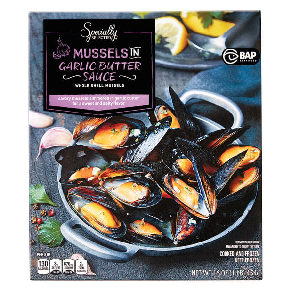 A box of Specially Selected Mussels in Garlic Butter Sauce, showing cooked mussels in shells in a black dish with sauce. The packaging highlights garlic butter flavor and indicates the product is cooked and frozen.