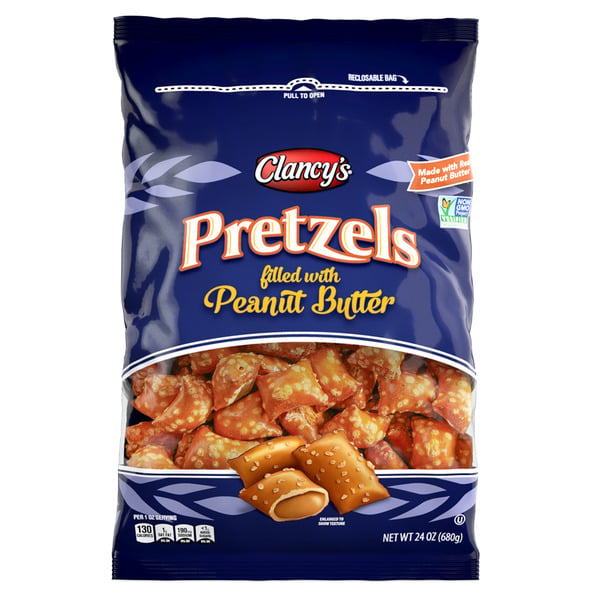 A blue resealable bag of Clancy’s Pretzels filled with peanut butter. The front shows the product name, images of the pretzel snacks, and highlights that they are made with real peanut butter. The bag weighs 24 oz (680g).