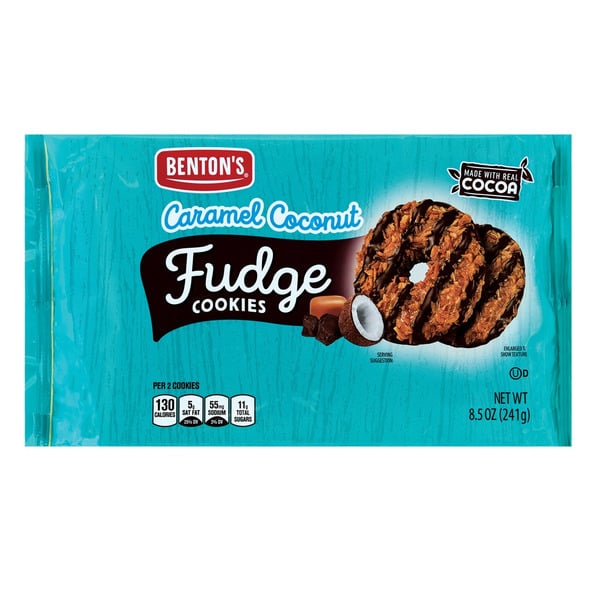 Package of Benton's Caramel Coconut Fudge Cookies featuring a photo of the cookies with caramel, coconut, and fudge, and a coconut split open. The package is blue and notes "Made with Real Cocoa." Net weight 8.5 oz (241g).