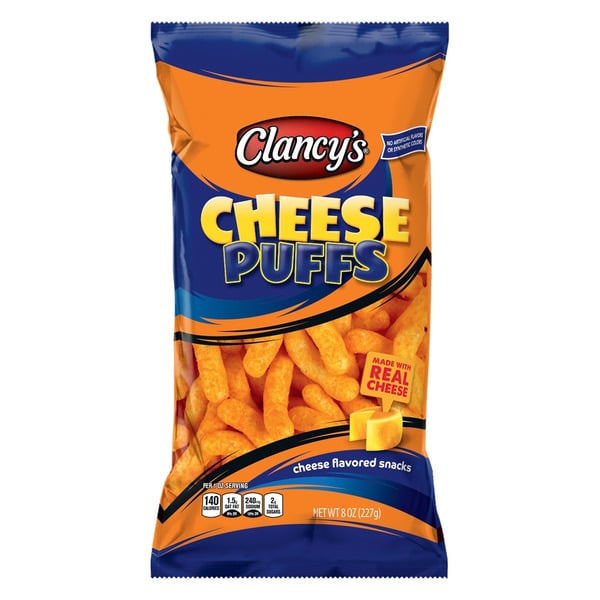 A bag of Clancy's Cheese Puffs featuring bold yellow and blue branding, with images of cheese puffs and cheese slices on the front. The bag advertises "Made with real cheese" and weighs 8 oz (227g).