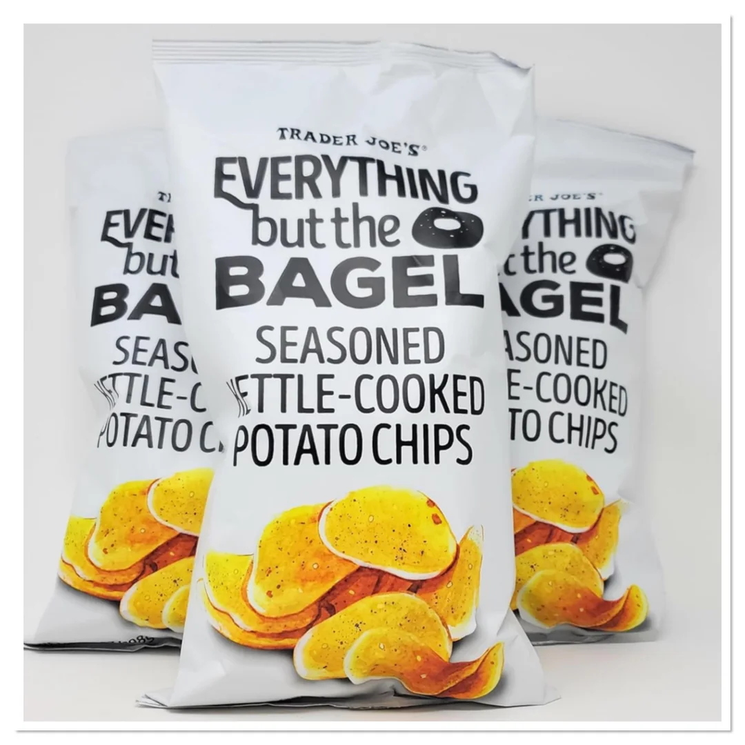 Trader Joe's products not worth buying. Three bags of Trader Joe’s Everything but the Bagel seasoned kettle-cooked potato chips are arranged with one bag in front and two slightly behind, featuring images of golden chips on the packaging.