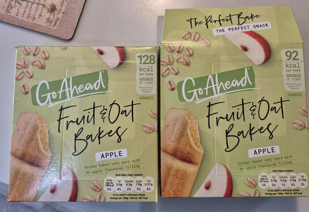 Two boxes of Go Ahead Fruit & Oat Bakes Apple flavor are shown. One box shows 128 kcal per bake and the other 92 kcal per bake. Both boxes display images of oat bars, apples, and oats on a green background.