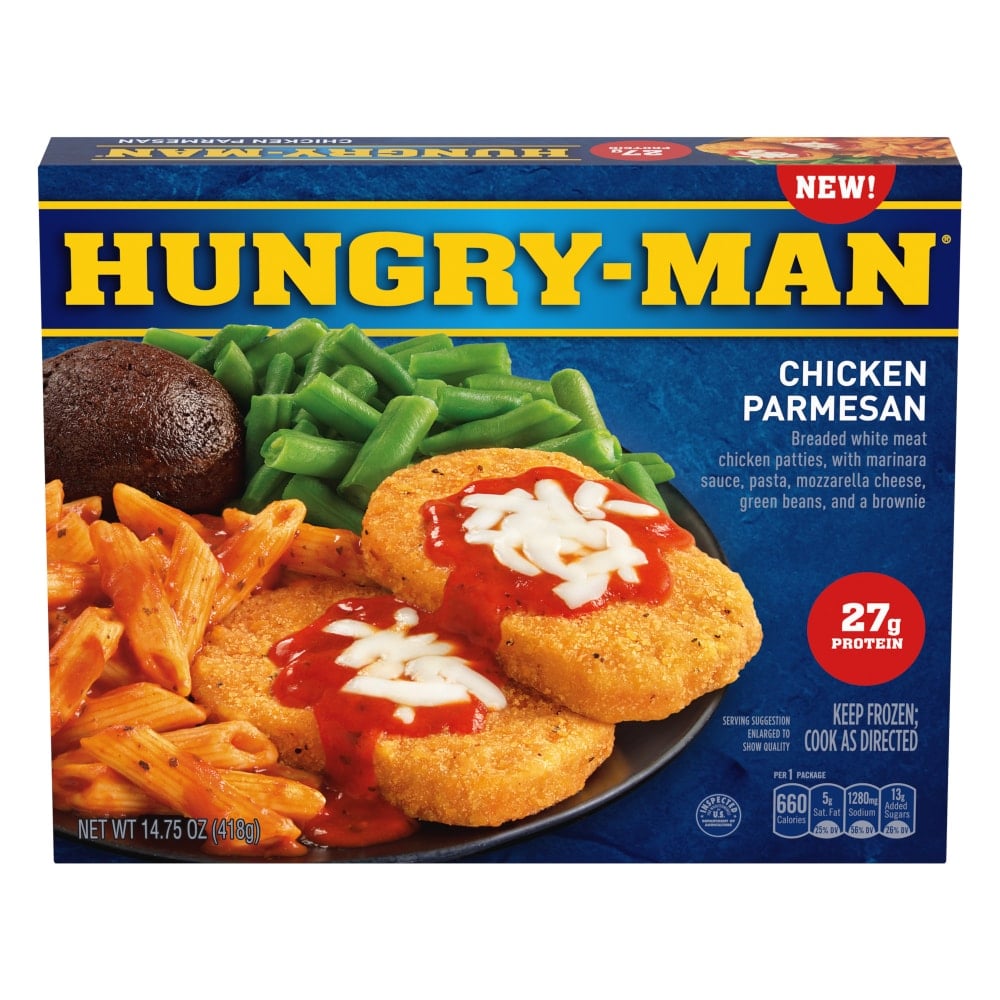 A box of Hungry-Man Chicken Parmesan frozen meal, featuring breaded chicken patties topped with marinara sauce and mozzarella cheese, pasta, green beans, and a brownie. The packaging highlights 27g of protein.