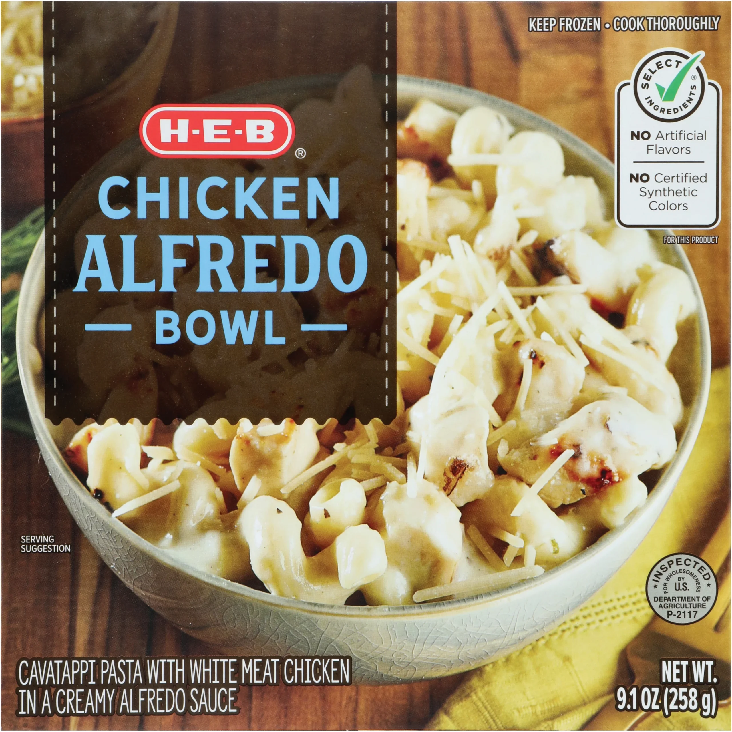 A bowl of H-E-B Chicken Alfredo featuring cavatappi pasta with white meat chicken in a creamy Alfredo sauce. The packaging notes no artificial flavors, no certified synthetic colors, and a net weight of 9.1 oz (258 g).