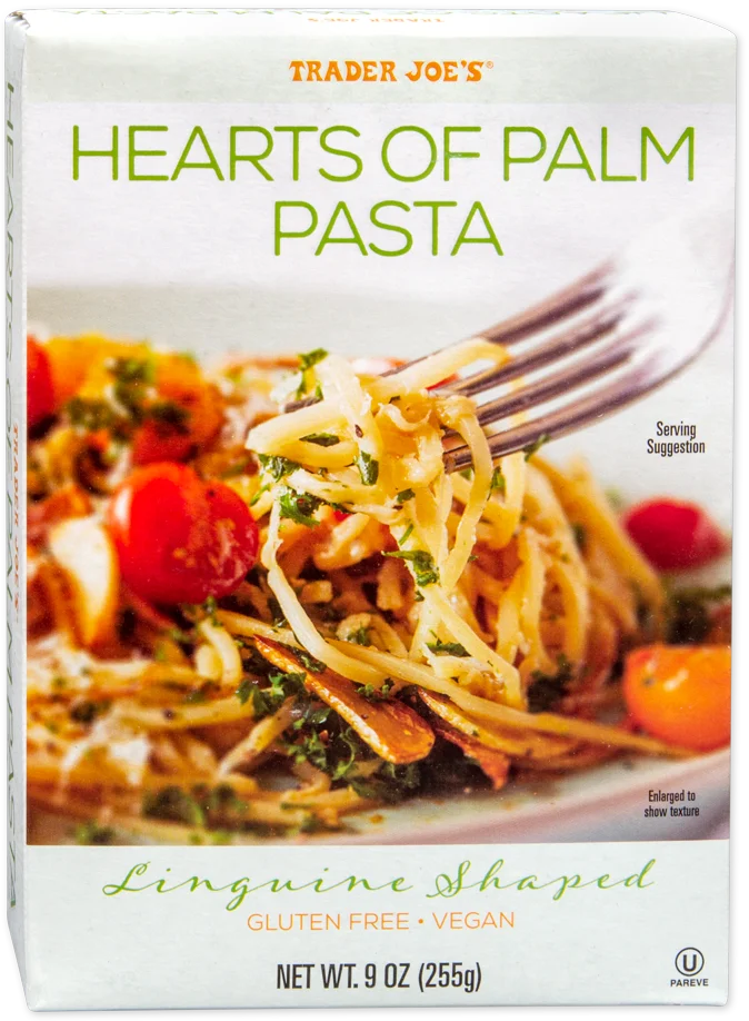 A box of Trader Joe’s Hearts of Palm Pasta, linguine shaped, gluten free, and vegan. The box features an image of the pasta with tomatoes and herbs, with a fork lifting noodles. Net weight is 9 oz (255g).
