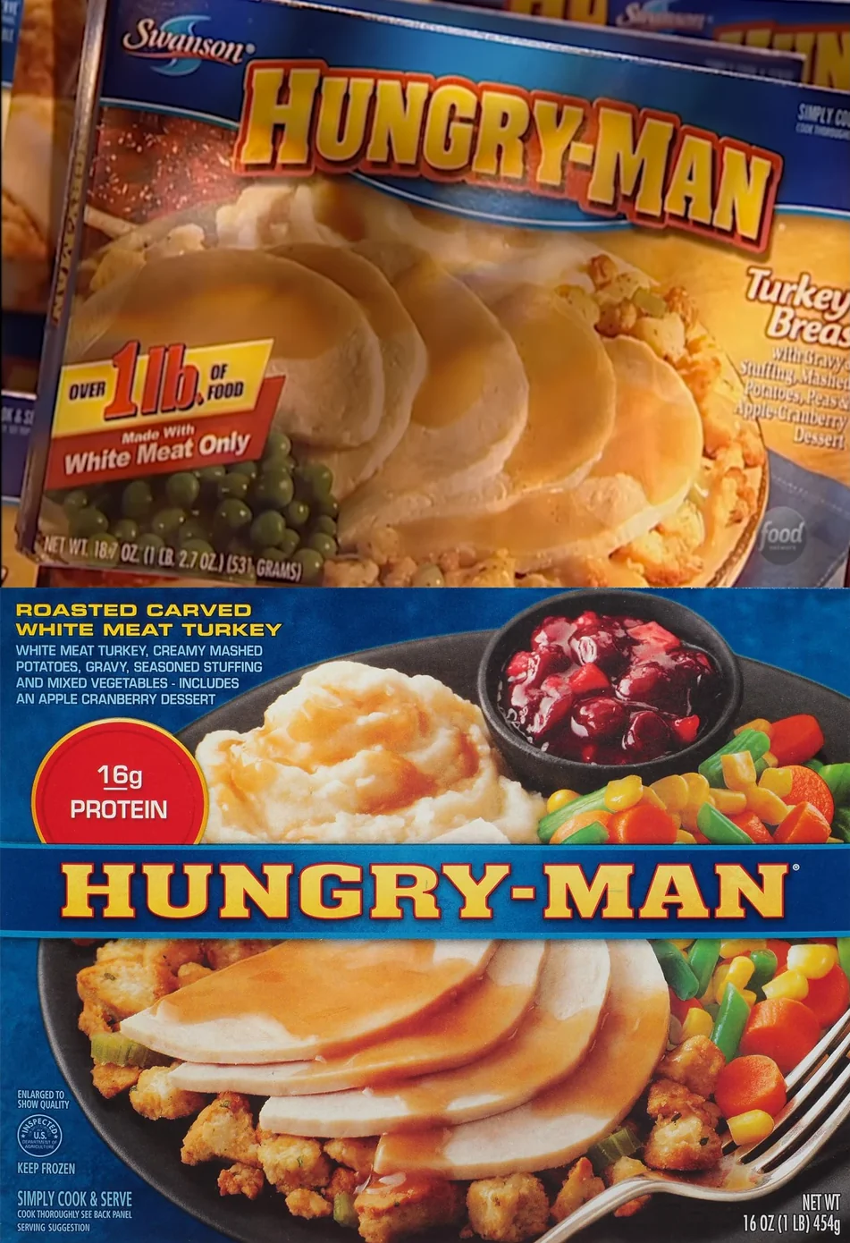 Two boxes of Hungry-Man frozen turkey dinners are shown. Each displays turkey slices with gravy, mashed potatoes, stuffing, corn or cranberry sauce, and labels promoting protein content and portion size.