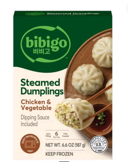 Box of Bibigo Steamed Dumplings, Chicken & Vegetable flavor, with dumplings on a plate and chopsticks showing the filling. Includes dipping sauce and instructions to keep frozen—perfect for those looking to buy in bulk for easy meals.