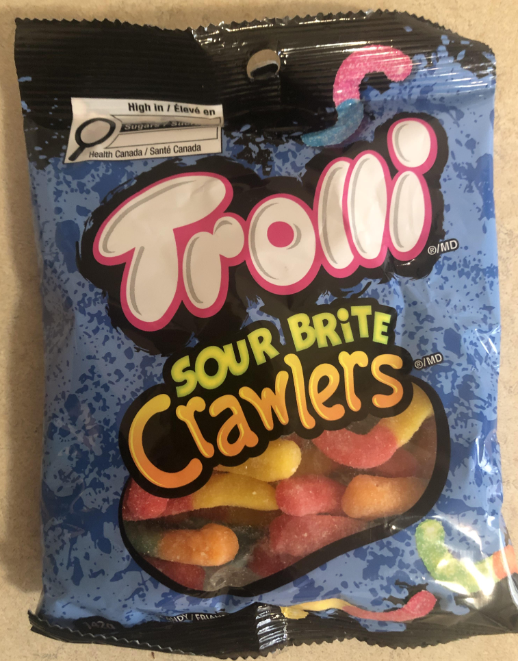 A bag of Trolli Sour Brite Crawlers, often called the best gummy candy, with a blue background and colorful gummy worms visible through a clear window at the bottom of the package.