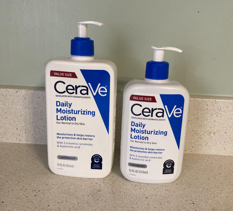Two bottles of CeraVe Daily Moisturizing Lotion with blue pumps are on a countertop. The left bottle is 19 oz, and the right is 16 oz. Both are labeled as value size and for normal to dry skin.
