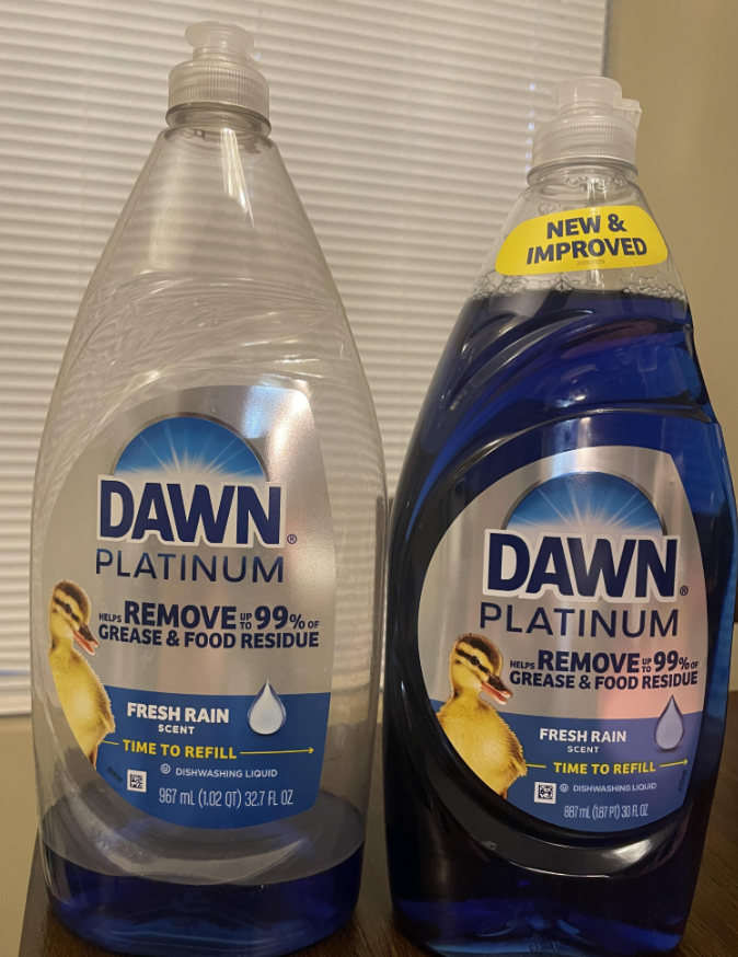 Two bottles of Dawn Platinum Fresh Rain dishwashing liquid are shown side by side; the bottle on the left is clear and empty, while the bottle on the right is new, full, blue, and labeled “New & Improved.”