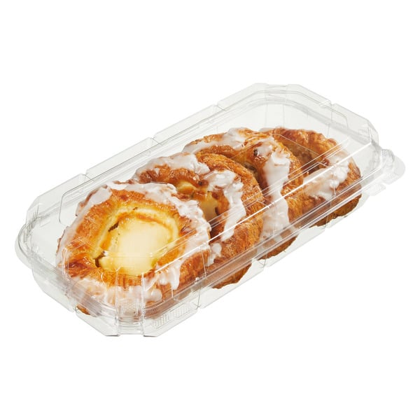 A clear plastic container holding three cheese danishes topped with white icing drizzle. The pastries are golden brown with creamy cheese filling in the center.
