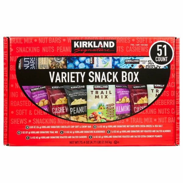 A red Kirkland Signature Variety Snack Box featuring 51 assorted snacks, including nut bars, trail mix, peanuts, cashews, and almonds. The box is labeled clearly and shows images of the snack packs inside.