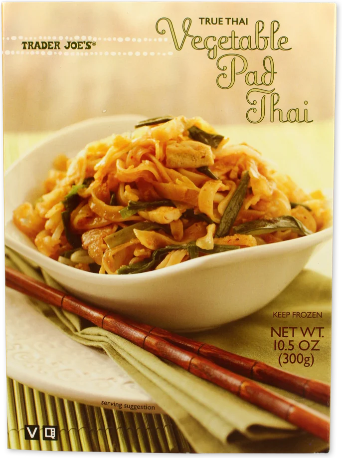 A box of Trader Joe’s True Thai Vegetable Pad Thai, showing a bowl of noodles and vegetables with chopsticks resting on a napkin beside it. The package includes weight and serving suggestion details.