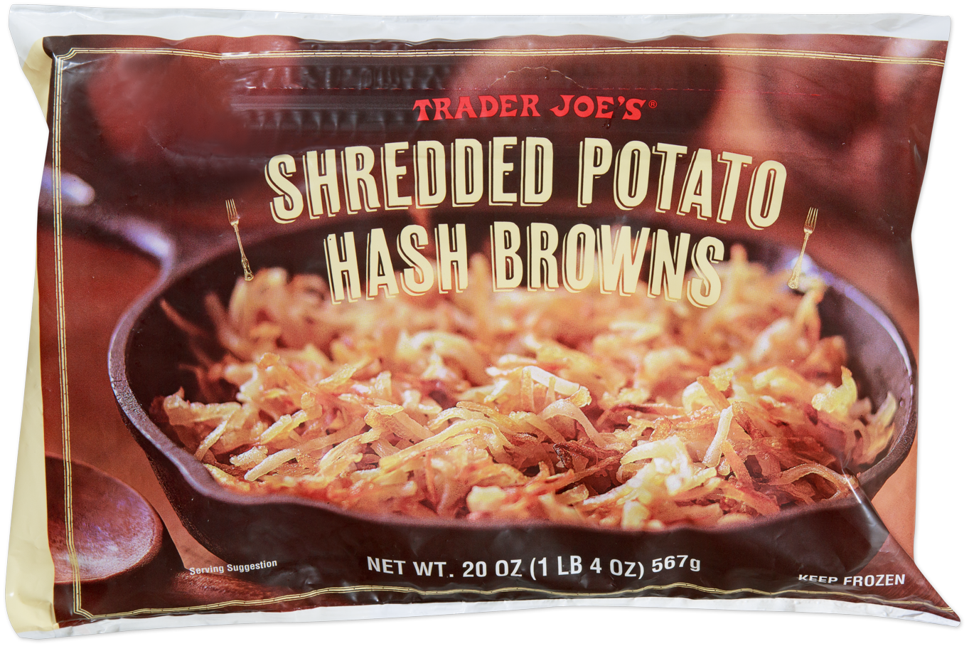 A bag of Trader Joe’s Shredded Potato Hash Browns features crispy hash browns in a cast iron skillet on the packaging. The net weight is 20 oz (1 lb 4 oz) or 567g, and the product is labeled “Keep Frozen.”