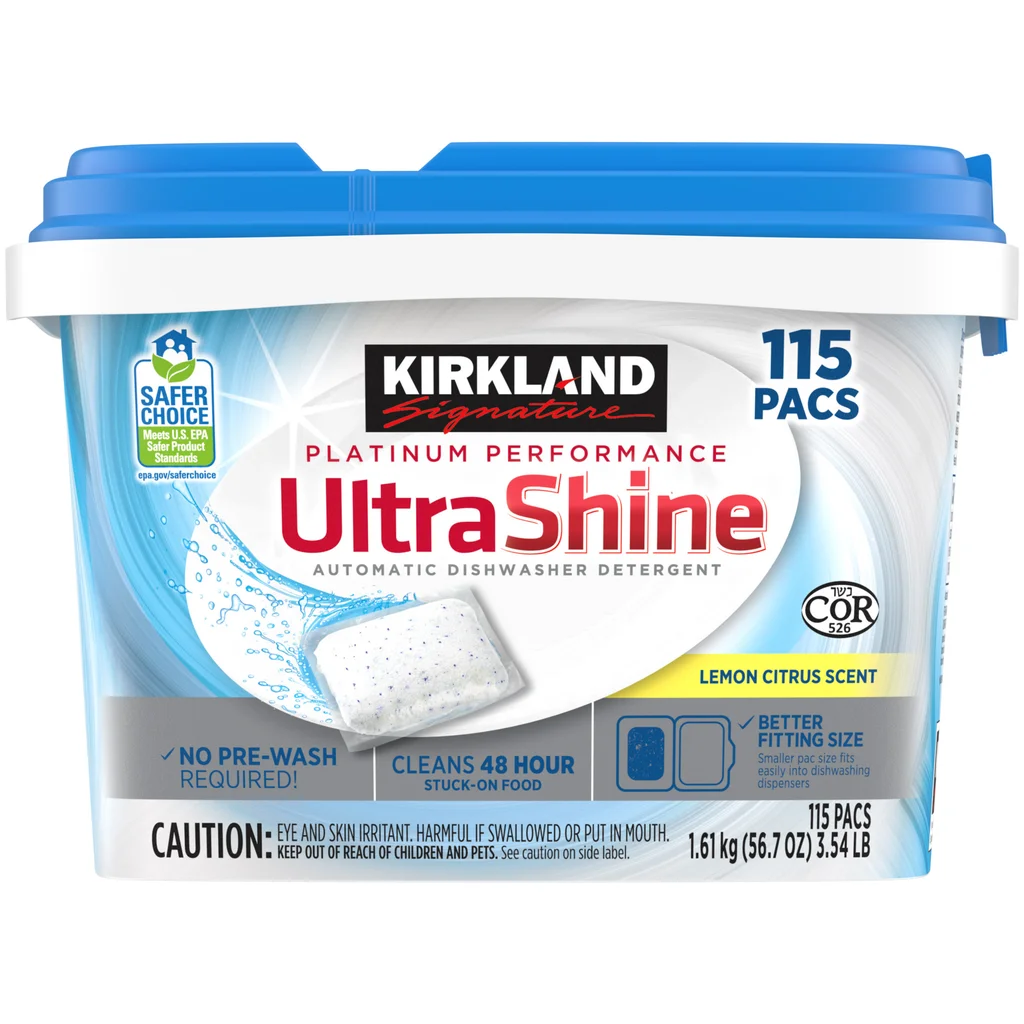 A container of Kirkland Signature UltraShine Automatic Dishwasher Detergent with 115 pacs, lemon citrus scent. The label highlights "Platinum Performance," no pre-wash required, and safer choice certification.