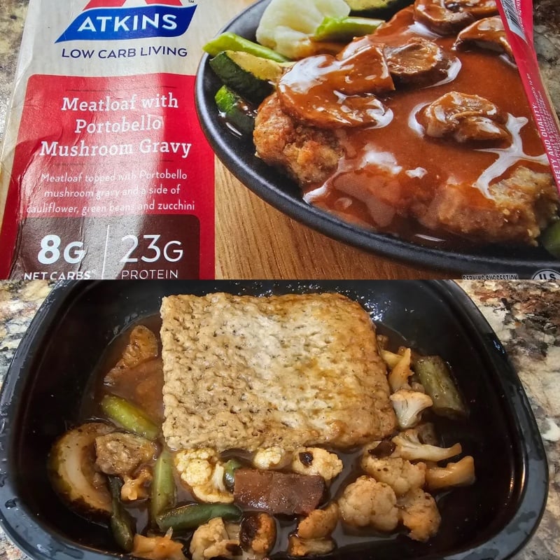 Atkins Low Carb Living Meatloaf with Portobello Mushroom Gravy meal box above opened meal showing meatloaf, gravy, and mixed vegetables including cauliflower, zucchini, and green beans.