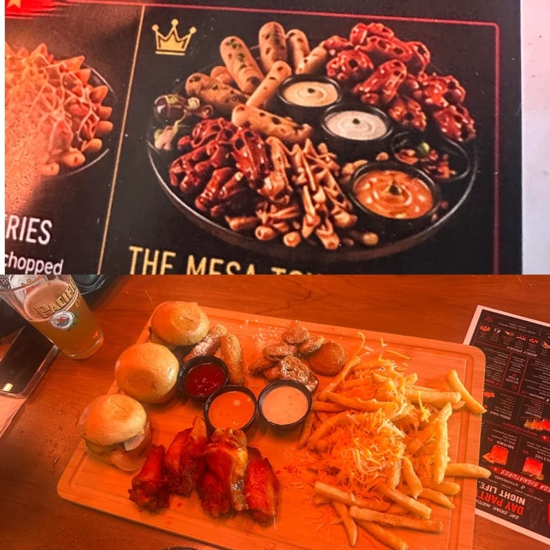 A menu photo shows a platter of appetizers. Below, the served platter has sliders, fries, wings, mozzarella sticks, pretzels, sauces, and a drink, all on a wooden board with a menu in the background.