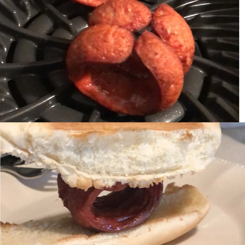 A curled, flower-shaped hot dog slice is cooked on a grill and then served in a sliced bun, forming a unique shape inside the sandwich.