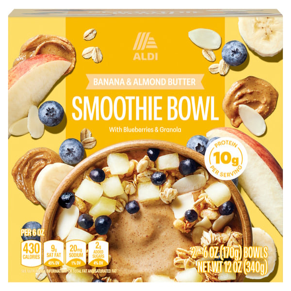 A box of ALDI Banana & Almond Butter Smoothie Bowl with blueberries, granola, apple slices, and almond butter pictured on the packaging. Text highlights protein content and serving size.