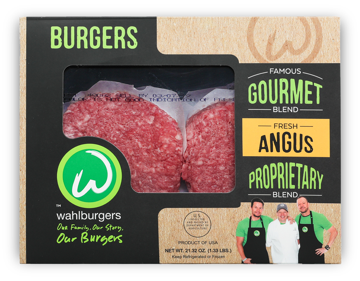 A box of Wahlburgers Angus burgers with two raw patties visible. The packaging features the Wahlburgers logo, branding text, and photos of three people in green shirts and chef attire at the bottom right.