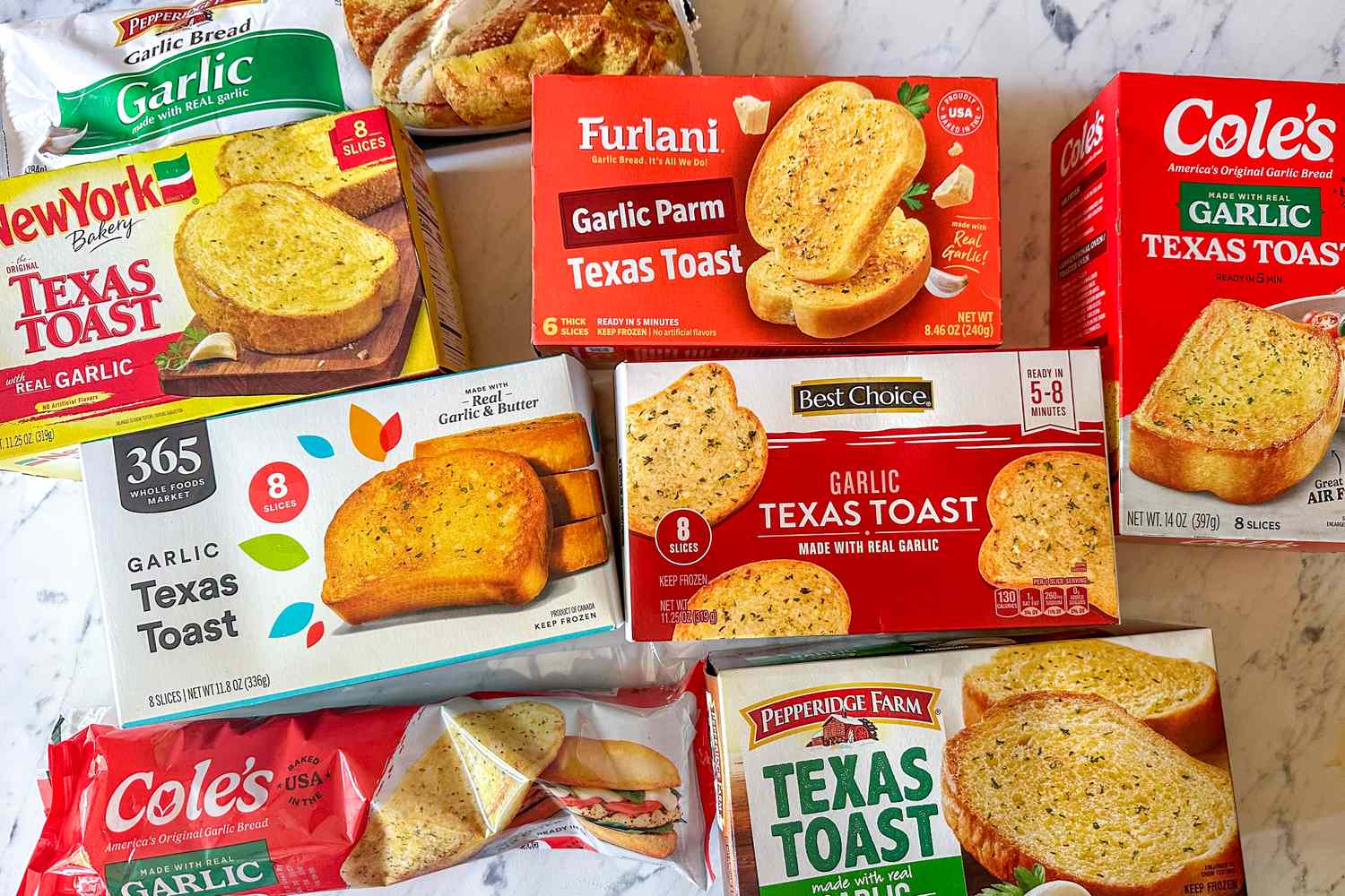 Various brands of garlic Texas toast in colorful boxes are arranged on a white marble surface, showcasing different packaging designs and types of frozen garlic bread.