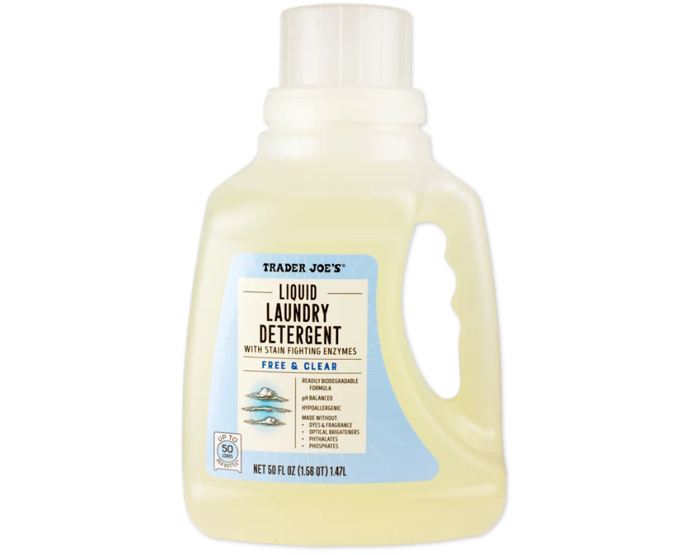A bottle of Trader Joe’s Liquid Laundry Detergent, labeled "Free & Clear," with stain-fighting enzymes and a measuring cap. The label is blue and white, and the bottle contains 50 fluid ounces of detergent.