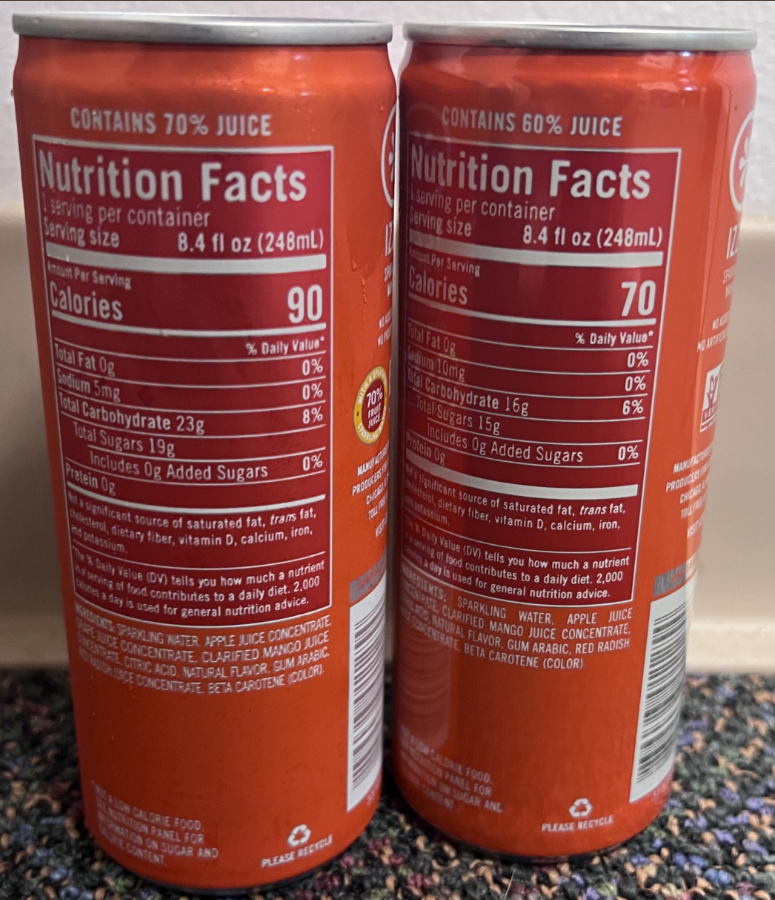 Two orange soda cans display nutrition facts labels, showing details like calories, total fat, sodium, total carbohydrates, sugars, and vitamins per 8.4 fl oz (248ml) serving. One can contains 90 calories, the other 70.