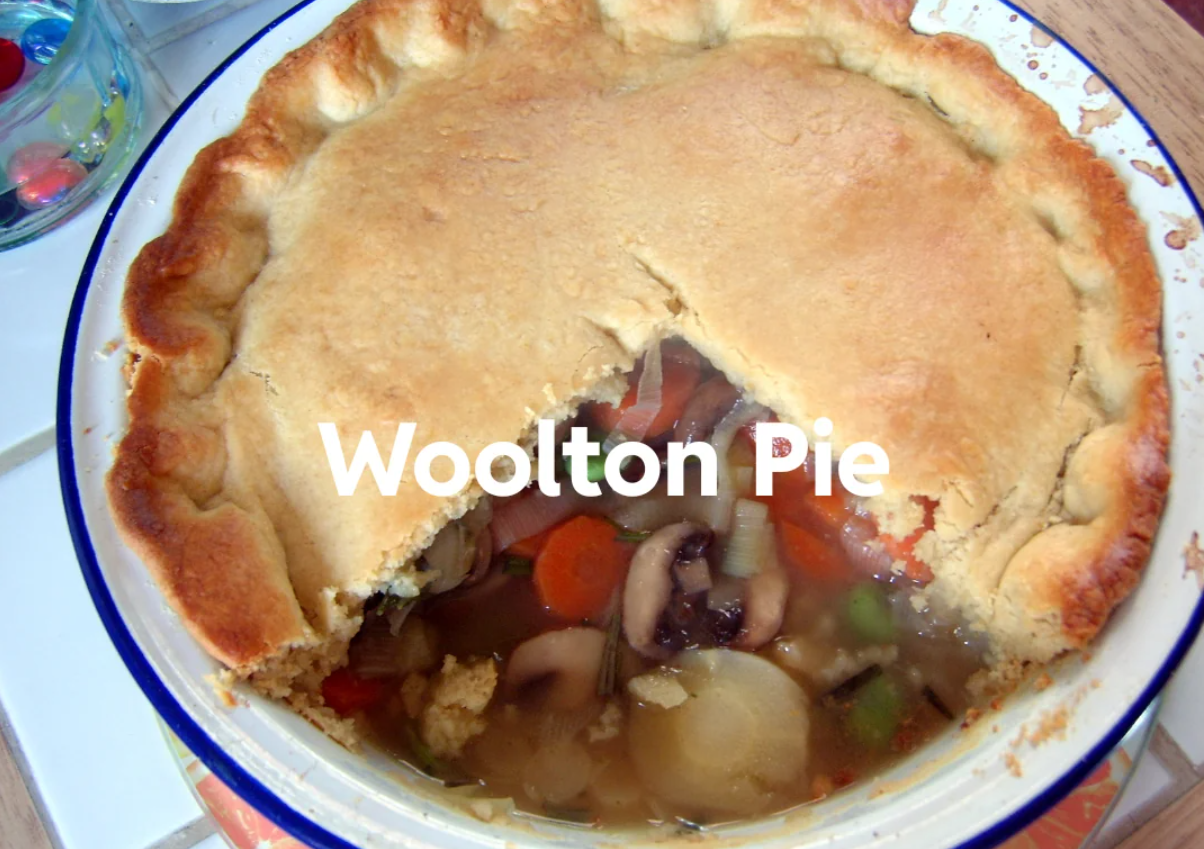 A baked Woolton Pie with a golden crust, a wedge removed to reveal a filling of vegetables like carrots, mushrooms, and potatoes. The words "Woolton Pie" are overlaid on the image.