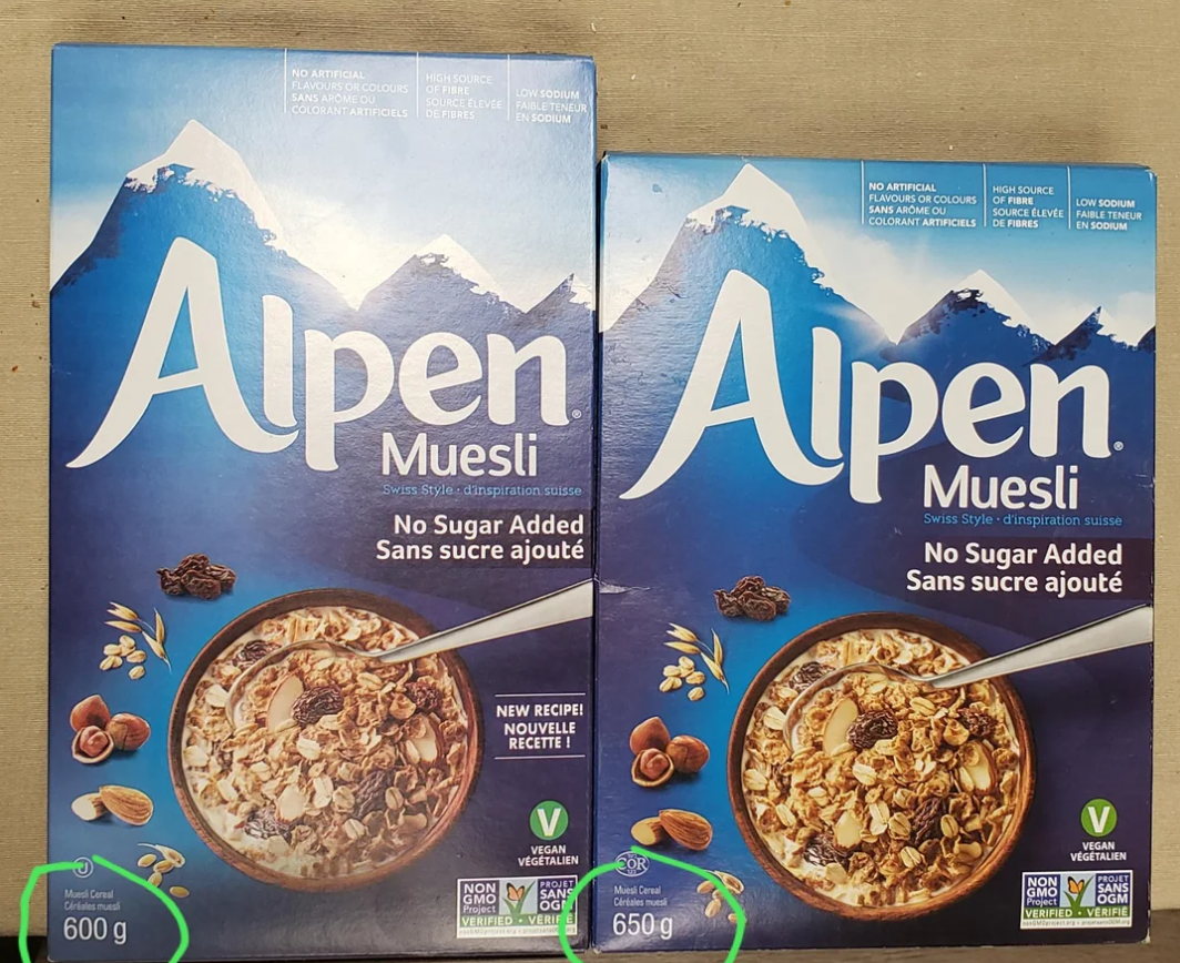 Two Alpen Muesli cereal boxes are shown side by side, capturing photos of shrinking products in action. The left box is 600g, while the right box is 650g. Both are labeled "No Sugar Added" and display a bowl of muesli on a blue mountain background.