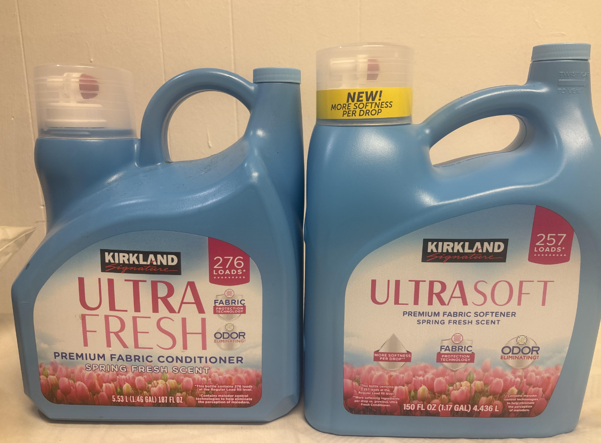 Two blue Kirkland Signature fabric softener bottles: one labeled "Ultra Fresh" (276 loads), the other "Ultra Soft" (257 loads), both with pink tulip graphics and "Spring Fresh Scent" text on the front—photos of shrinking products like these highlight changing load counts over time.