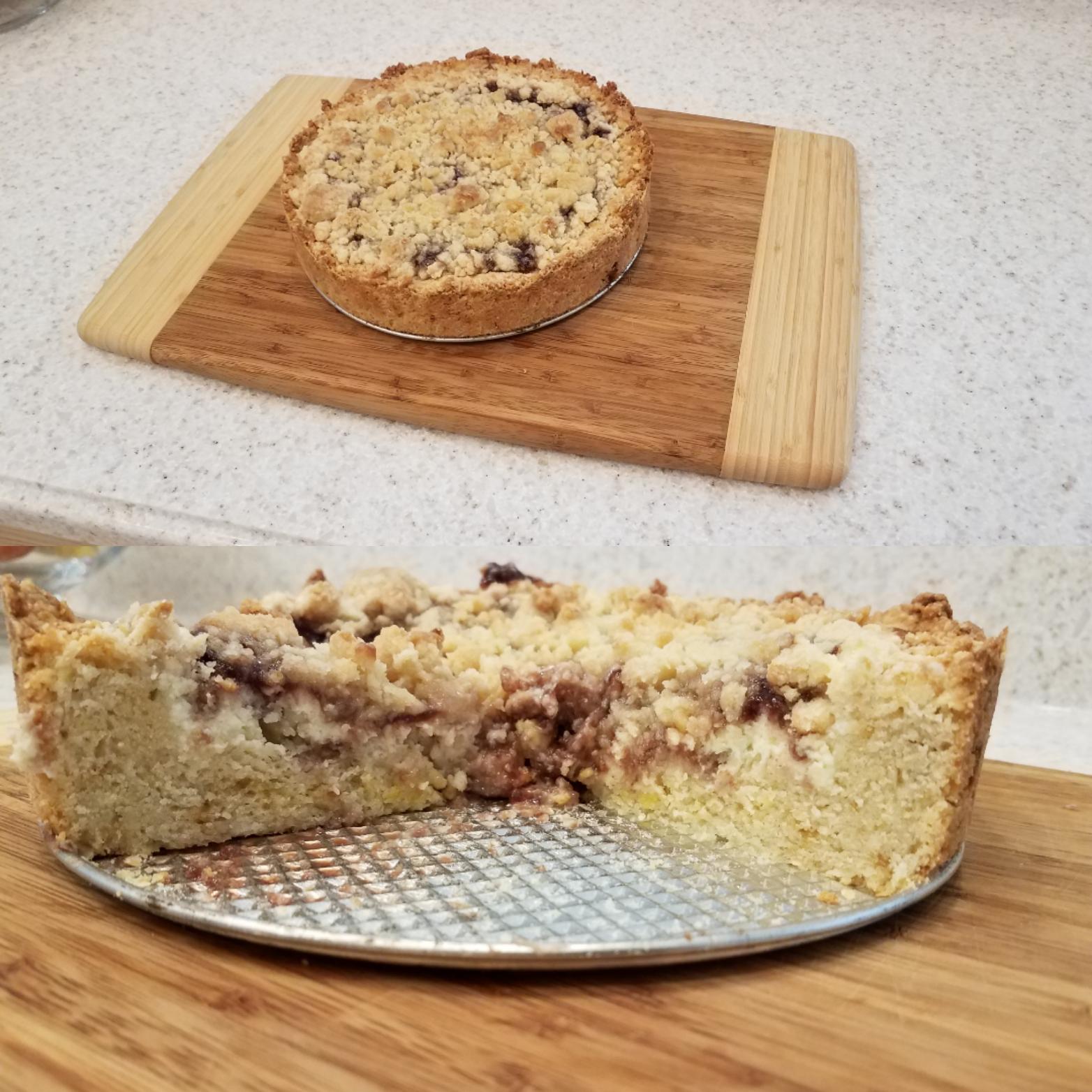 A round crumb cake sits on a wooden board; in the second image, the cake is sliced to show its crumbly topping and moist interior with swirls of filling on a metal springform pan base.