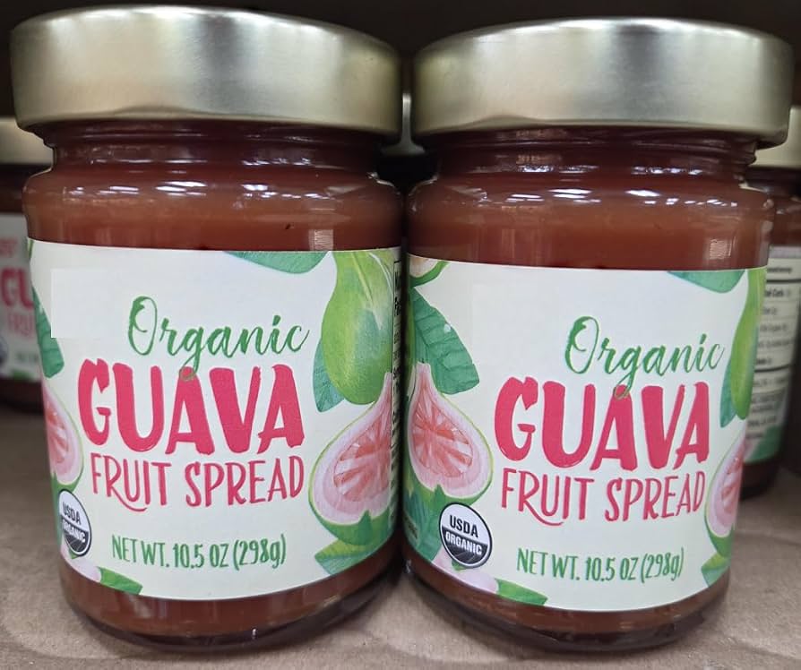 Two jars of organic guava fruit spread with gold lids are side by side. The labels are white with green and red text, and feature illustrations of guavas. Each jar weighs 10.5 oz (298g).