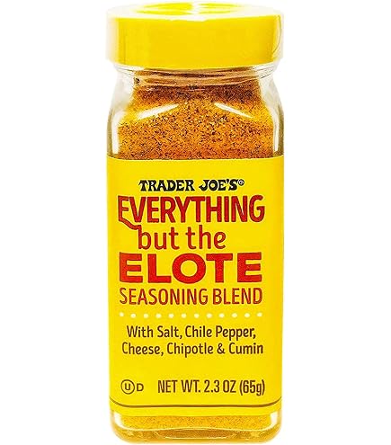 A bottle of Trader Joe's Everything but the Elote Seasoning Blend with a yellow label, listing salt, chile pepper, cheese, chipotle, and cumin as ingredients. Net weight is 2.3 oz (65g).