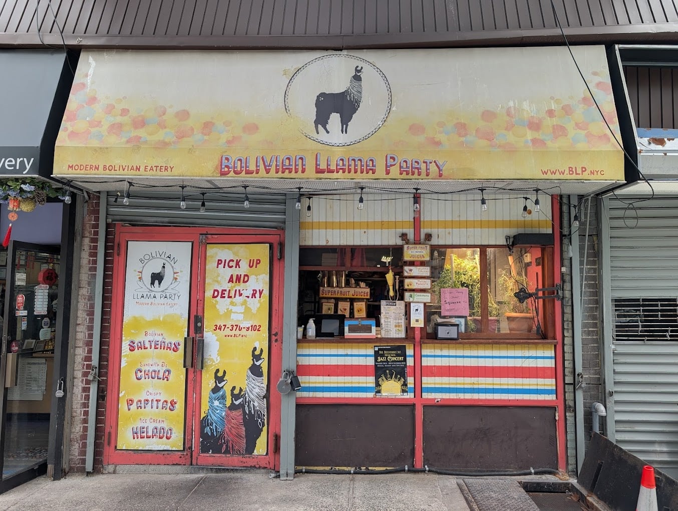 Storefront of "Bolivian Llama Party," a modern Bolivian eatery, with a llama logo, colorful signage, and text advertising takeout and delivery; the window displays various food items and boxes.