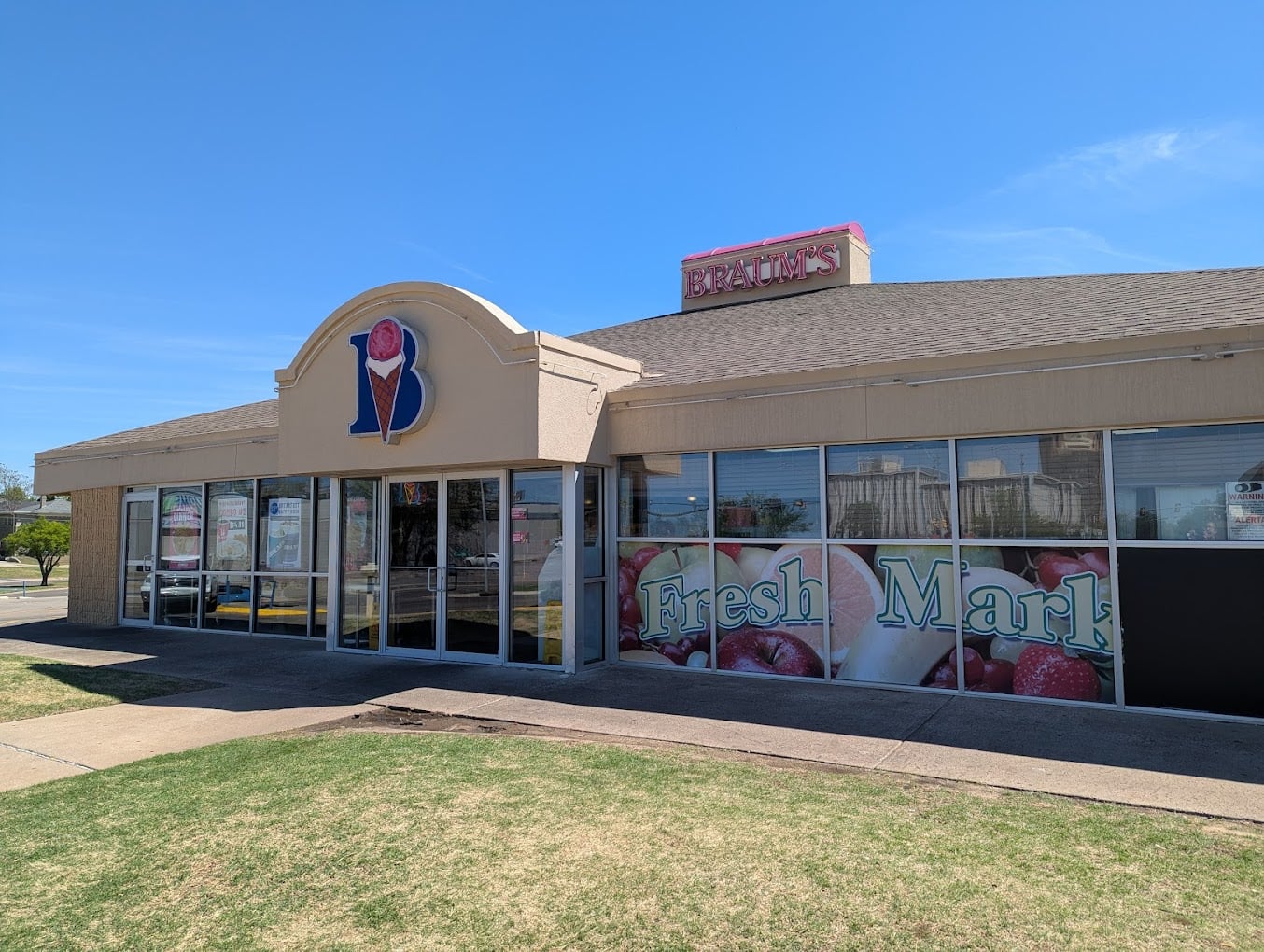 A Baskin-Robbins ice cream shop with large front windows and a sign on the roof sits under a clear, sunny sky. The windows display strawberries with “Fresh Mar” visible—a sweet spot often ranked among favorite fast-food chains by state.