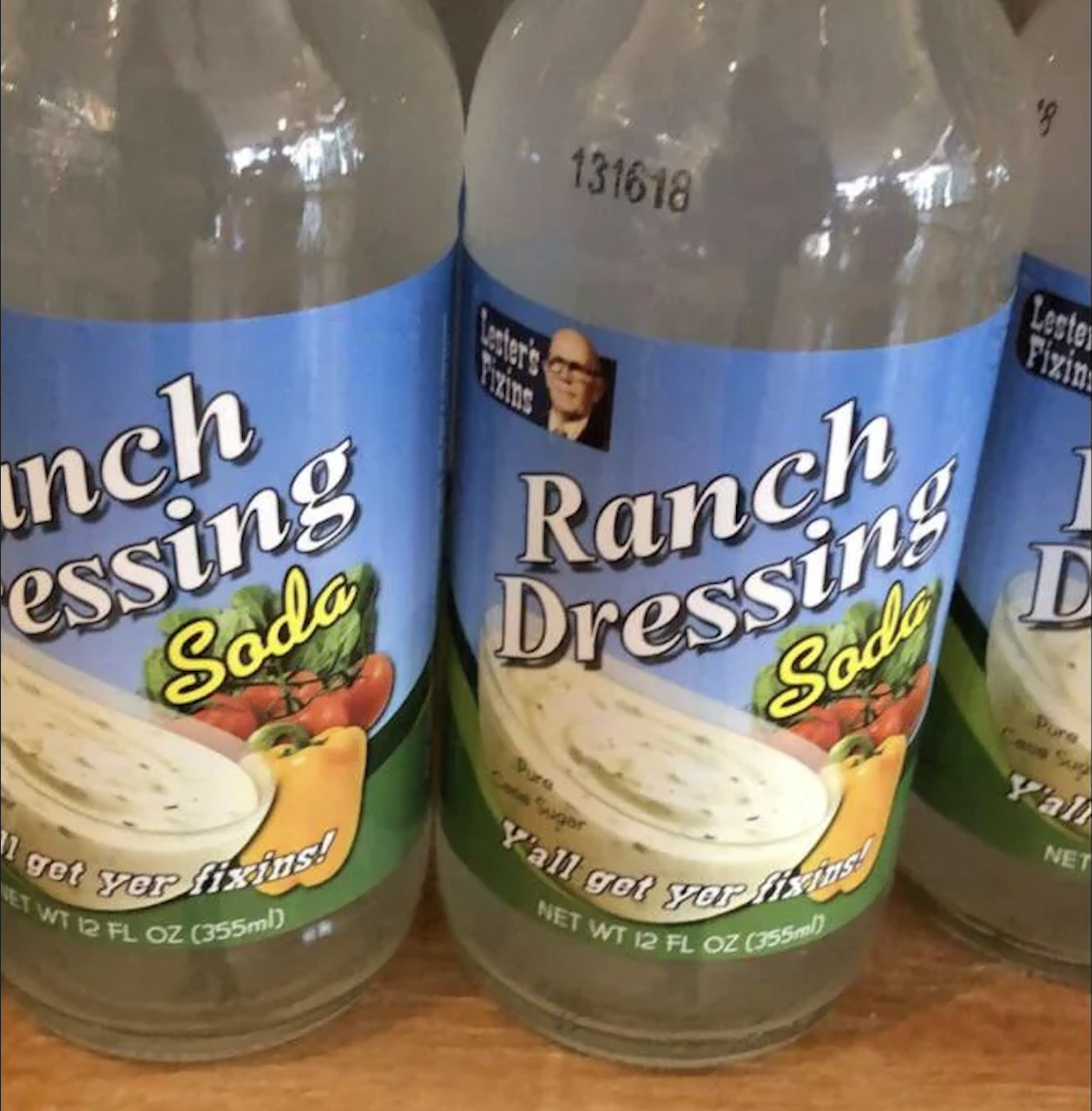 Bottles labeled “Ranch Dressing Soda” with images of vegetables and ranch dressing; the label says “Y’all get your fixins!” and features a small portrait of a man.