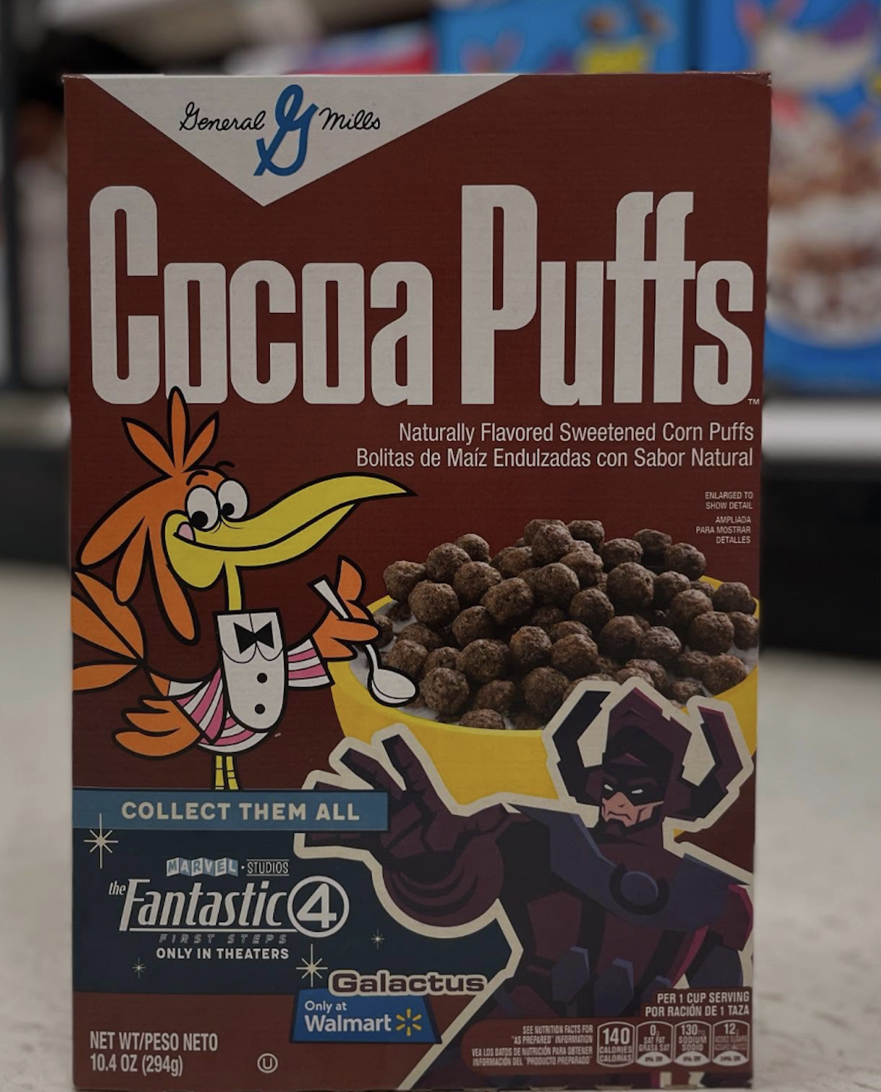 A Cocoa Puffs cereal box featuring Sonny the Cuckoo Bird and Marvel’s Galactus, with Fantastic Four movie branding and “Collect Them All” text. The box displays chocolate cereal puffs and nutrition info.