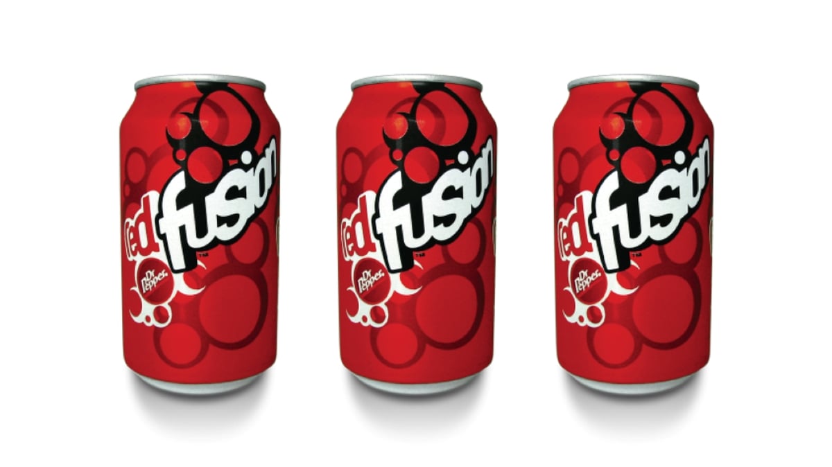 Three red cans of Dr Pepper Red Fusion Soda Pops are lined up side by side against a white background. The cans feature a bold logo with large red bubbles and black and white text.