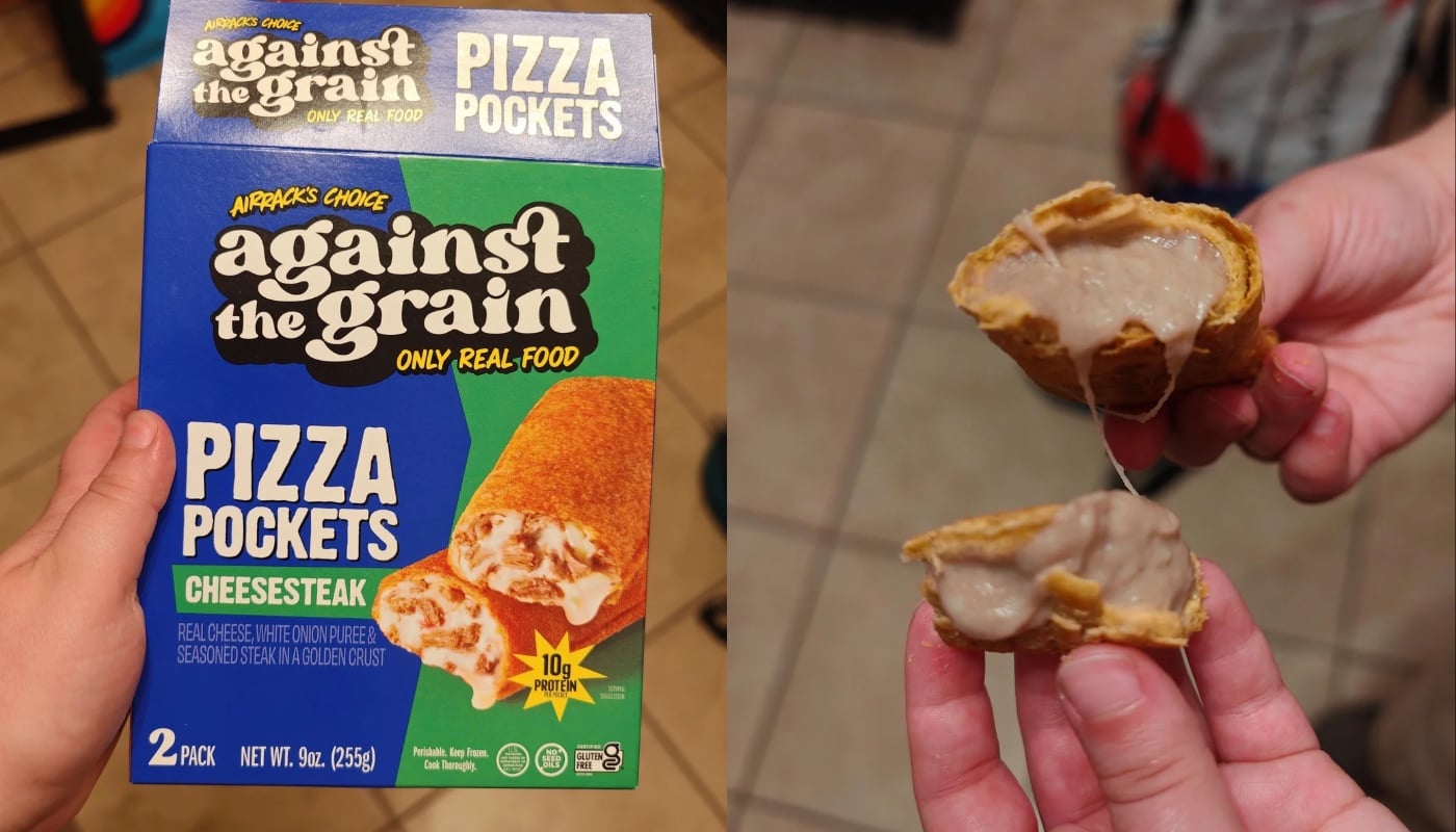 A hand holds a box labeled “Against the Grain Pizza Pockets Cheesesteak.” Another hand splits open a cooked pizza pocket, revealing a thick, gooey beige filling inside.
