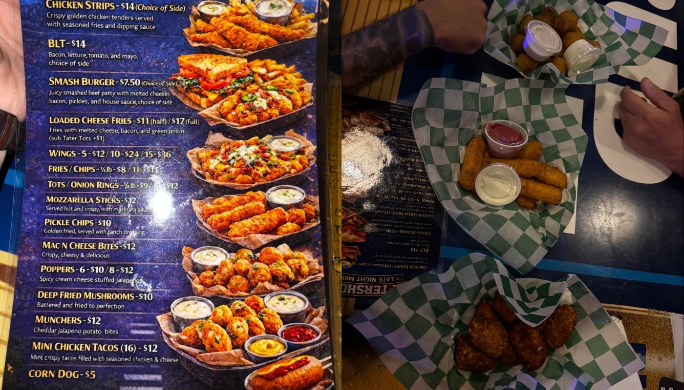 A menu featuring appetizers like wings and cheeseballs is shown on the left; on the right, hands reach for baskets of fried foods with dipping sauces on a table covered in green checkered paper.