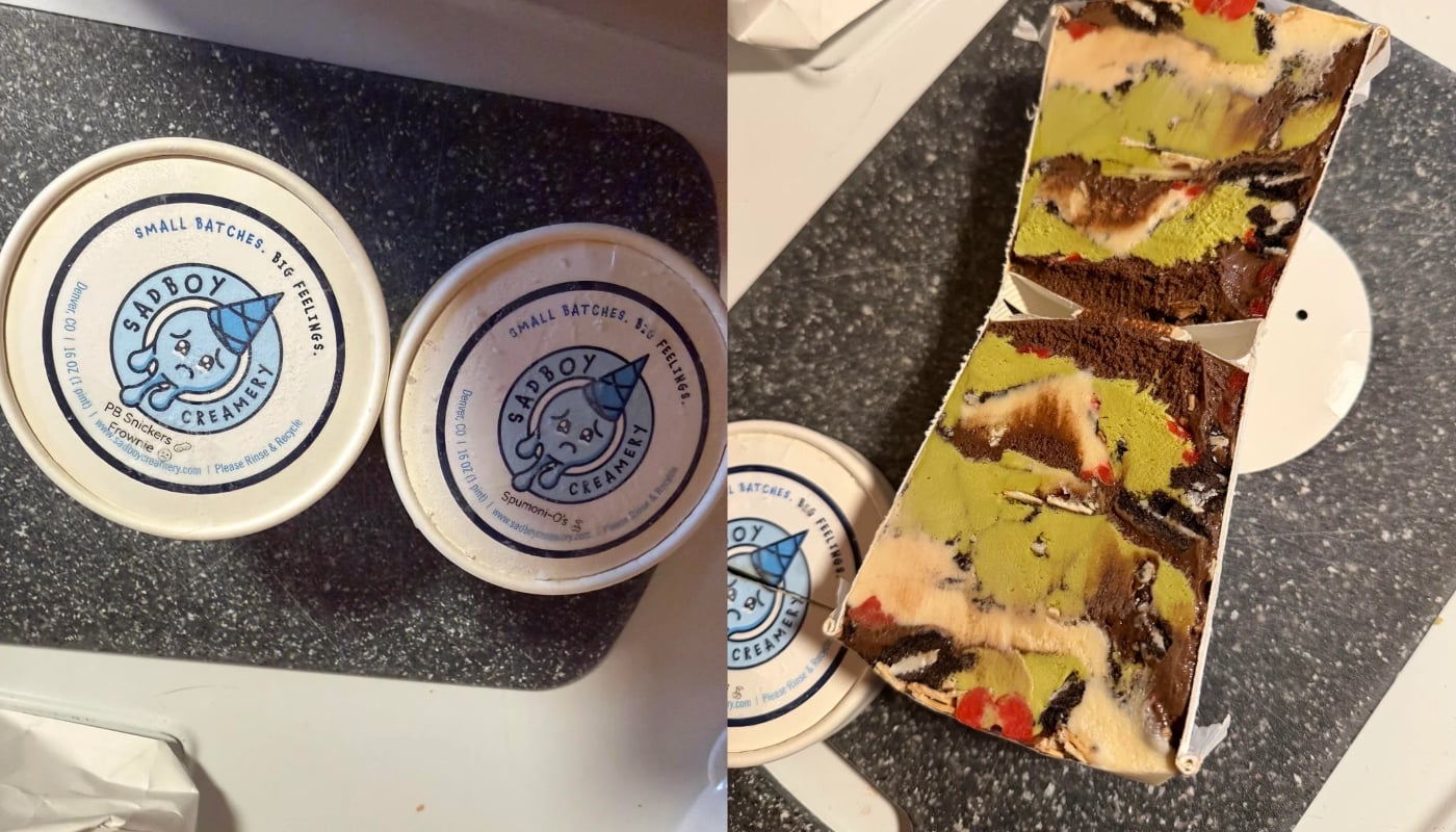 Two ice cream pints with “Sadboy Creamery” labels are on the left. On the right, a cut pint reveals colorful, layered ice cream with chocolate, green, yellow, and red sections on a dark countertop.