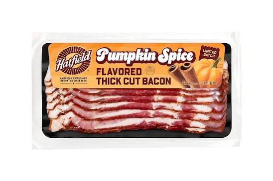 Packaged Hatfield Pumpkin Spice Flavored Thick Cut Bacon, limited batch, with images of cinnamon sticks and a pumpkin on the label. The bacon slices are visible through the packaging.