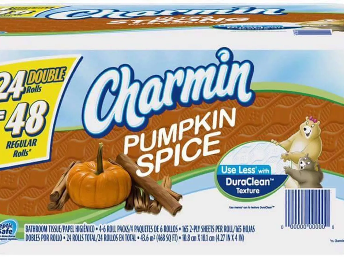 Charmin Pumpkin Spice toilet paper packaging, featuring a pumpkin, cinnamon sticks, and cartoon bears on the front. Text highlights 24 double rolls and DuraClean texture.