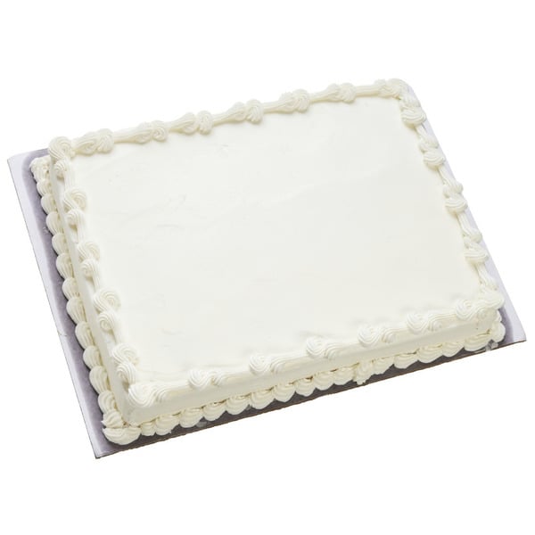 A rectangular sheet cake with smooth white frosting and decorative white icing borders, displayed on a rectangular cake board.